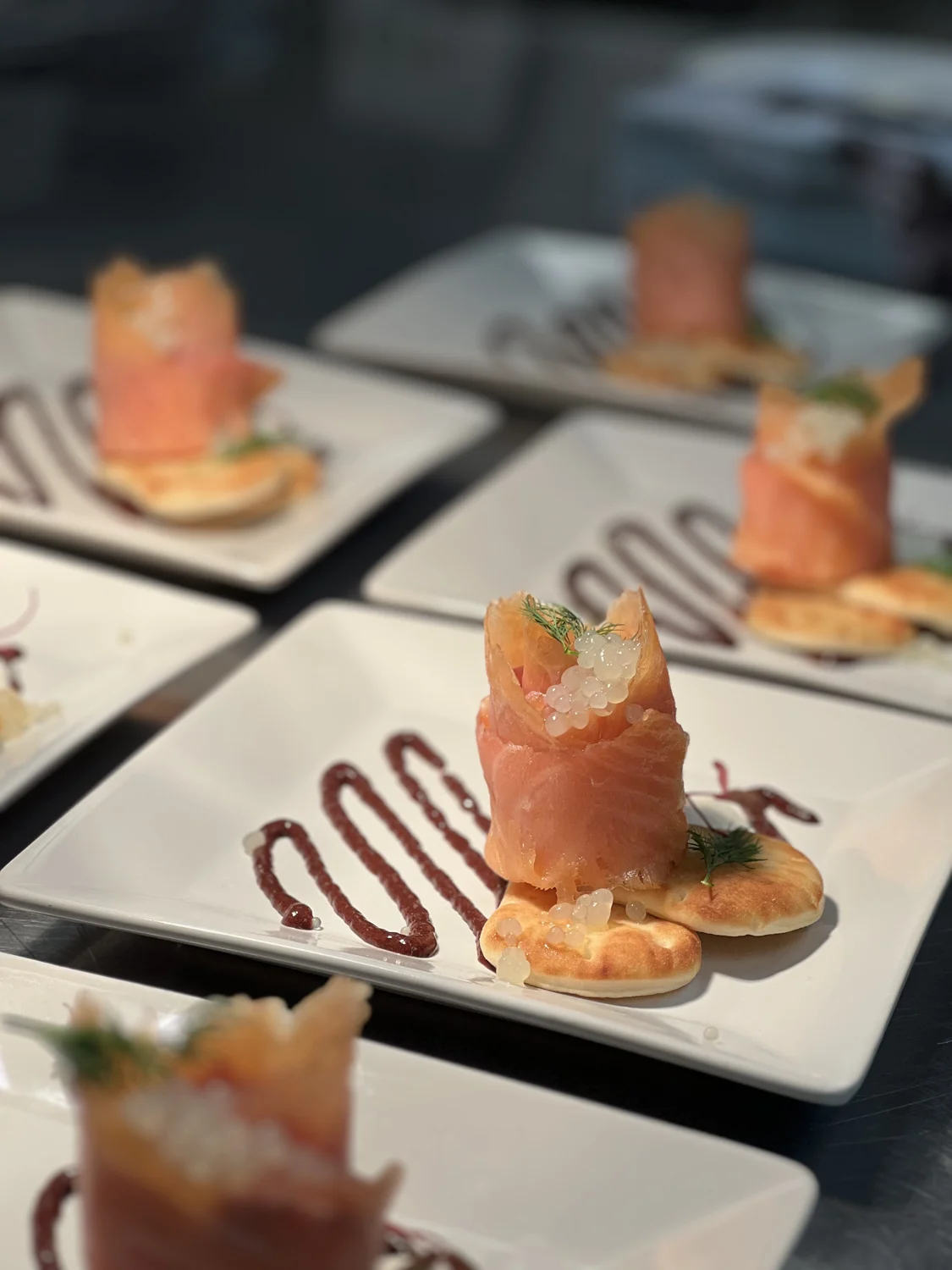 Individually plated rolled bites with herbs and sauce in the SPBH kitchen