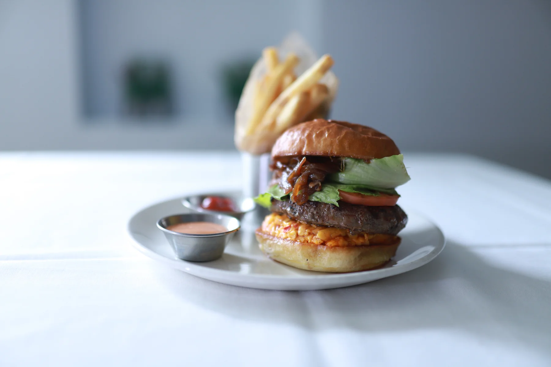 SPBH burger and fries at a dining-room table