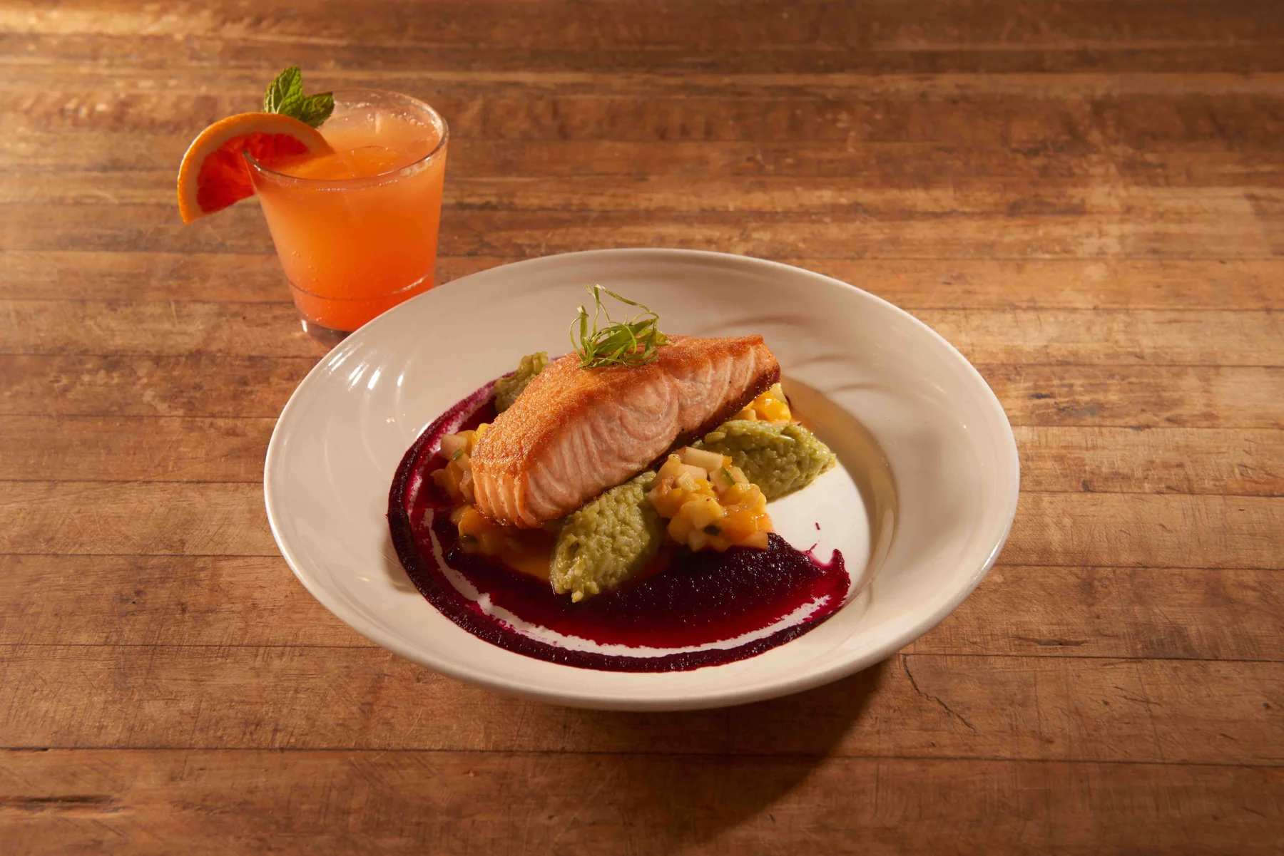 Grilled salmon with colorful accompaniments at Sandy Point