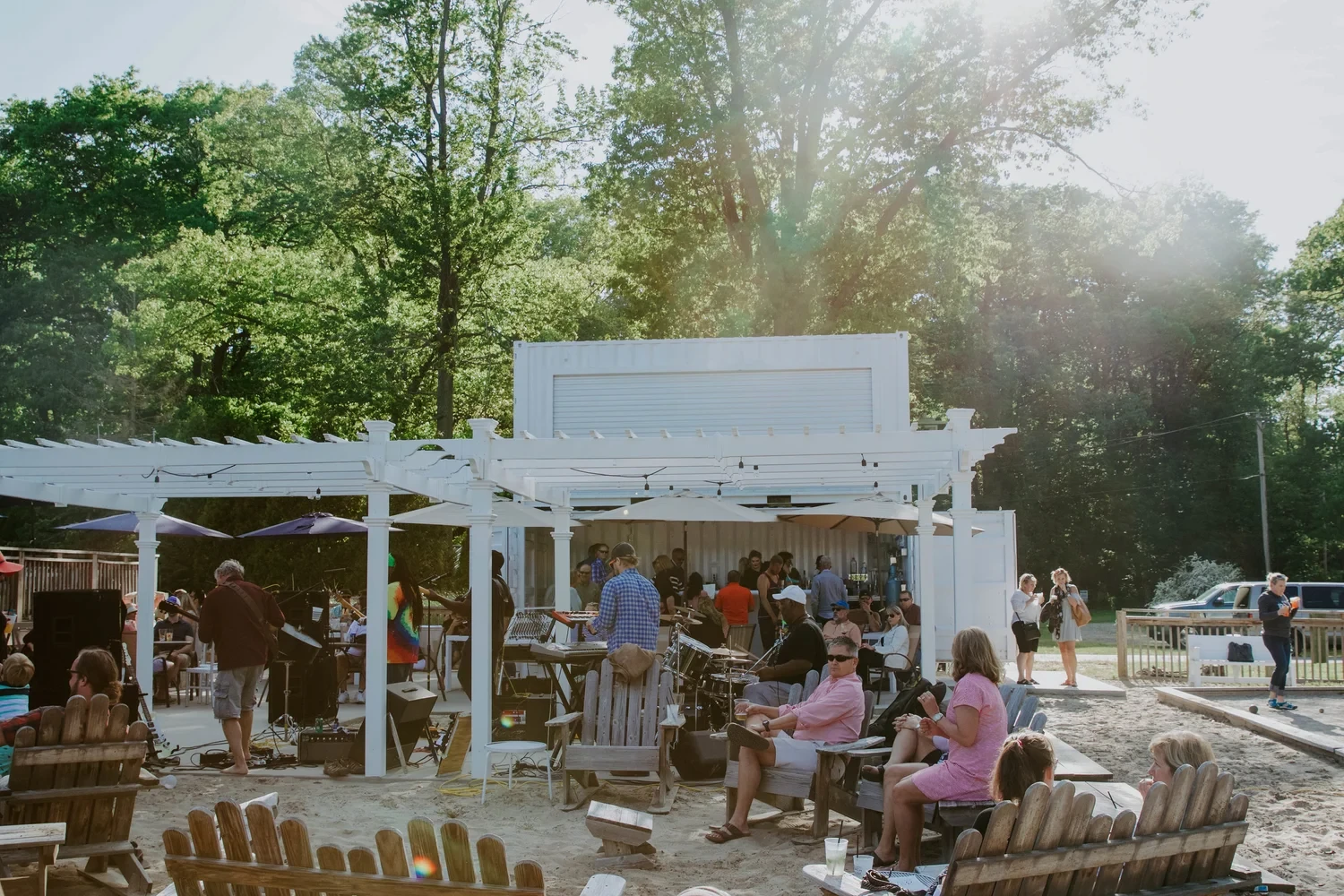 Guests enjoying a summer afternoon around Sandy Point’s outdoor bar